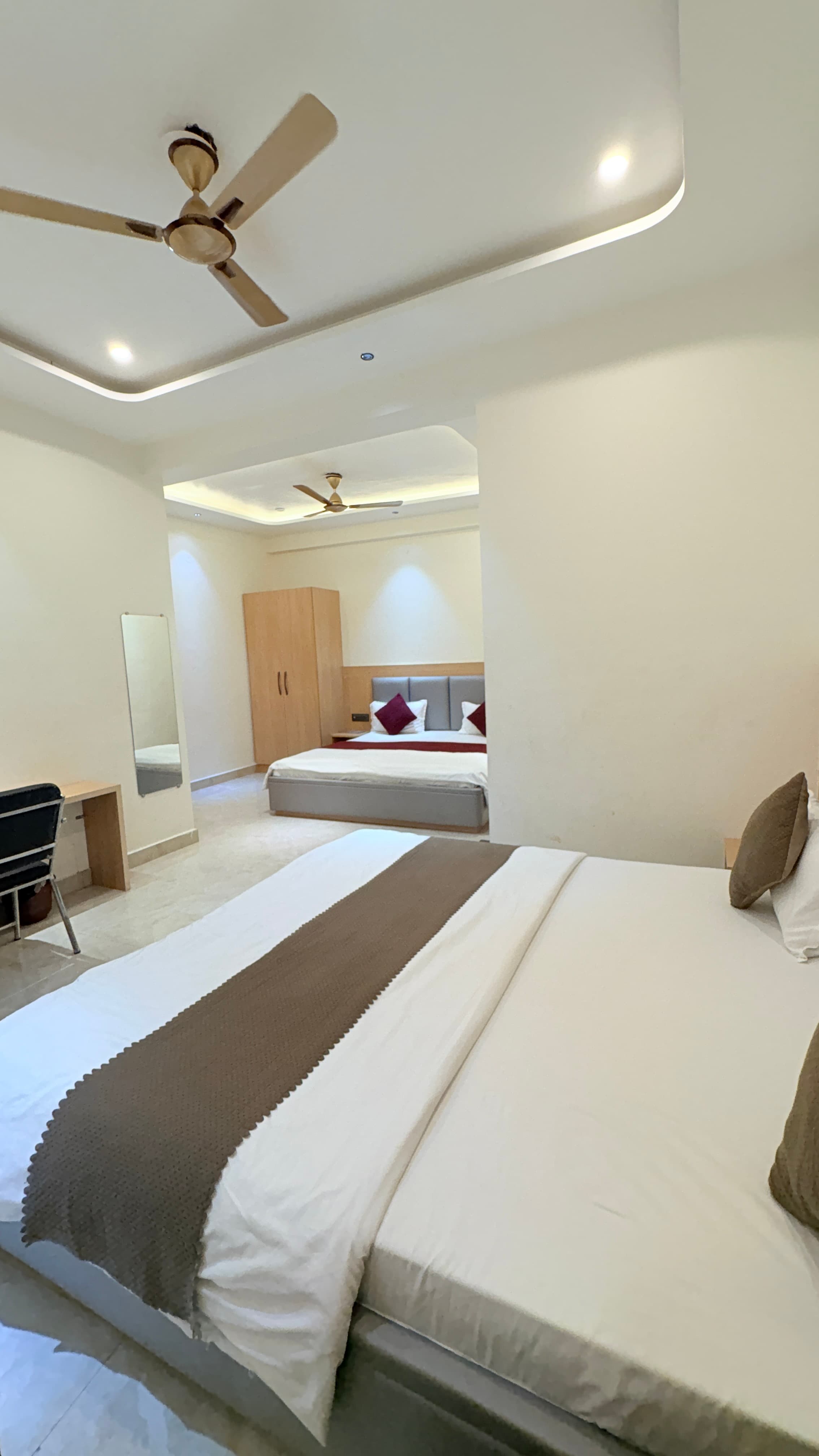 Family room with two large beds, wardrobe, and a writing desk